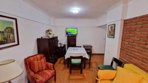 a living room with a table and chairs and a tv at San Bernardo in San Bernardo