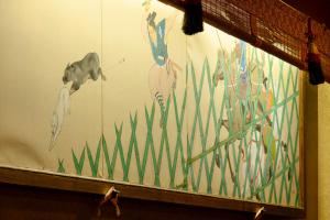 a wall with a painting of fish and grass at Kanouya in Omachi