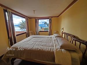 a bedroom with a bed and a large window at Arco Iris in Comunidad Yumani