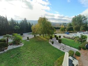 a view of a garden from the balcony of a house at Hotel La Perla Blanca in Ronda