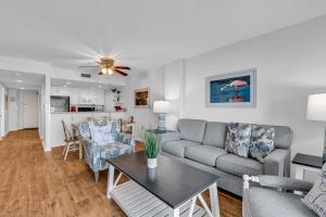 a living room with a couch and a table at Bluewater Resort 502 in Myrtle Beach +40 photos