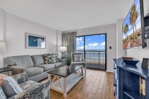 a living room with a couch and a table at Bluewater Resort 502 in Myrtle Beach