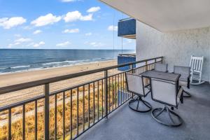a balcony with a table and chairs and the beach at Bluewater Resort 502 in Myrtle Beach