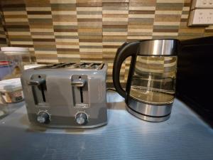 a toaster sitting on a counter next to a coffee maker at Tropical Almond Haven in Suva