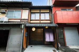 una entrada a un edificio con dos puertas de garaje en Rinn Rokujo Machiya, en Kioto