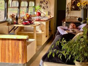 a man laying in a bed in a room at Fiery Peak Glampsite with Stargazing & Hot Tub in Geraldine