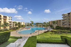 Una vista de una piscina en un resort. en Beachfront - Summer View 2BR condo - A244, en Palm-Eagle Beach