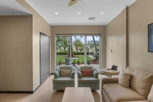 a living room with two couches and a table at Eagle Beach - Garden Breeze 1BR condo - LV101 in Palm-Eagle Beach