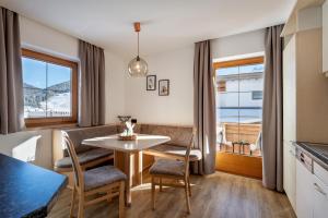 a kitchen and dining room with a table and chairs at Chalet Andreashof in Gerlos