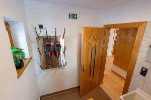 a room with a door with ski equipment on the wall at Chalet Andreashof in Gerlos