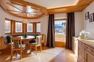 a kitchen and dining room with a table and chairs at Chalet Andreashof in Gerlos