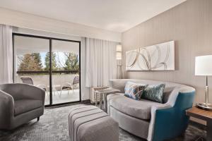a living room with a couch and a chair at Courtyard by Marriott San Jose South/Morgan Hill in Morgan Hill