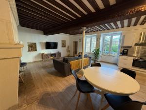 a living room with a table and a couch at La Loge Lingonne in Langres