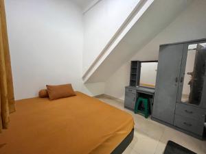 a bedroom with a bed and a dresser and a tv at Sejahtra Rawamangun in Jakarta