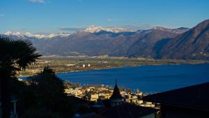 a view of a city and a large body of water at Ferienwohnung C04 in Orselina