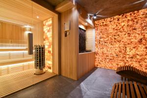 Habitación con pared de piedra y 2 sillas en Salamandra SPA Jacuzzi, Sauny, Tężnia, panorama Tatr, en Kościelisko