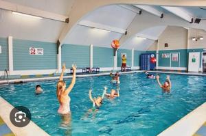 a group of people playing in a swimming pool at 9 Sea View Kessingland Beach Parkdean Resorts MIN 3 NIGHT STAY in Kessingland