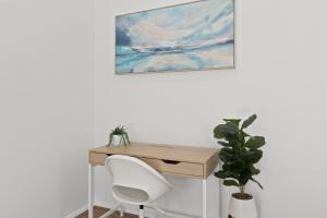 a desk with a chair and a painting on the wall at Quiet 2-Bed Retreat with Private Courtyard in Glenelg