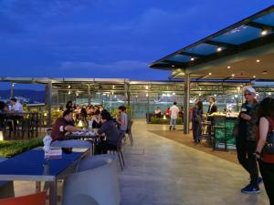 people sitting at tables on the roof of a building at Le Quadri Kuala Lumpur By UCSI Hotels in Kuala Lumpur
