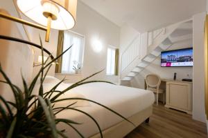 a hotel room with a bed and a staircase at Hotel Ai Dogi in Palmanova
