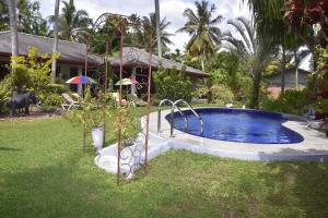 a swimming pool in the yard of a house at Daisy Villa in Aluthgama