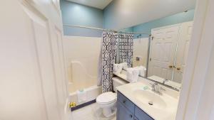 a bathroom with a white toilet and a sink at 2 Bedroom Villa in Gated Litchfield by the Sea in Pawleys Island +21 photos