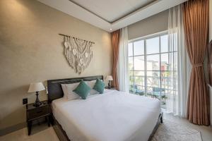 a bedroom with a bed and a large window at AnnA Home Novaworld Phan Thiết in Bình Tú +51 photos