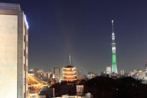 a view of a city at night with a tv tower at Richmond Hotel Premier Asakusa International in Tokyo