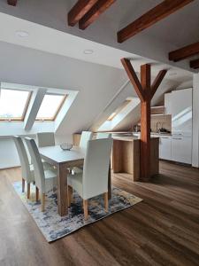 a dining room with skylights and a table and chairs at Brick House Residence in Poprad