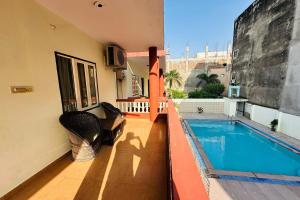 a house with a swimming pool on a balcony at Tiger Safari Resort, Ranthambhore in Sawāi Mādhopur