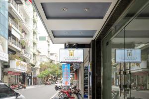 a building with signs on the side of a street at Hanoi Bliss Mai Hac De in Hanoi