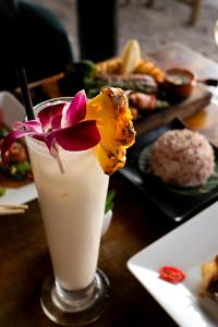 a drink with a flower on top of a table at The Lazy Lodge in Ko Lanta