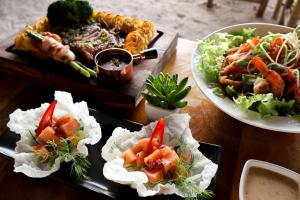 a table with three plates of food on it at The Lazy Lodge in Ko Lanta