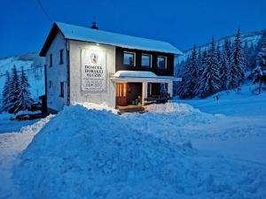 a building with a pile of snow in front of it at Domček Horskej Služby in Vyšná Boca
