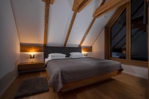 a bedroom with a bed and a large window at Ambient Resort Bled in Bled +52 photos