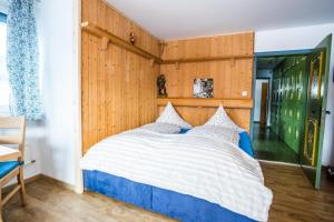 sypialnia z dużym łóżkiem i drewnianą ścianą w obiekcie Appartement Amalie by MoniCare w mieście Seefeld in Tirol +14 zdjęć