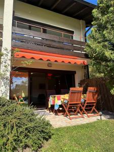 two chairs and a table in front of a house at Haus MARGOT by MoniCare in Seefeld in Tirol