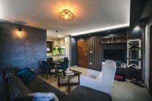 a living room with a couch and chairs and a table at Bajin chalets in Dobroselica