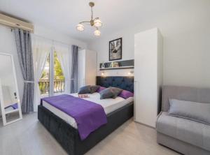 a bedroom with a large bed and a couch at Apartment Tafra 1 in Lokva Rogoznica