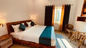 a bedroom with a bed and a window at GreenDay Escapes Rishikesh in Rishīkesh