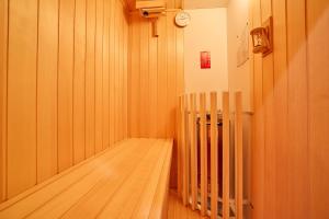 a room with a wooden floor and a clock on the wall at MIYA HOUSE Funatsu B in Fujikawaguchiko