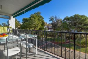 a patio with tables and chairs on a balcony at Strandapartment Sunnybeach Dénia in Denia +7 photos
