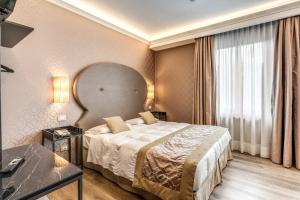 Postel nebo postele na pokoji v ubytování Hotel Belle Arti