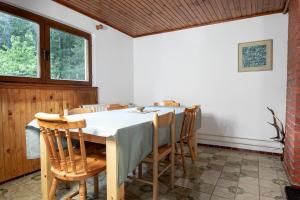 a dining room with a table and chairs at House Angelca in Hočko Pohorje +2 photos