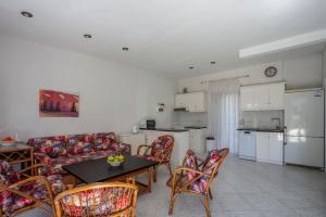 a kitchen and a living room with a table and chairs at Villa Mira in Pefkohori