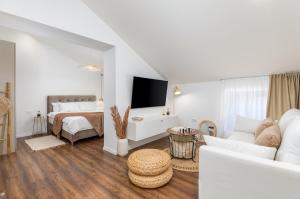 een witte woonkamer met een bank en een bed bij Travel Station in Pula