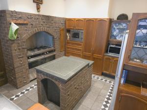 a kitchen with a brick oven in a kitchen at 169 Forbury Road in Dunedin +5 photos