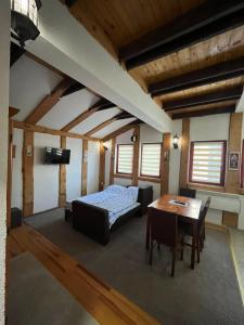 a bedroom with a bed and a table in a room at Apartments Gaga in Jahorina
