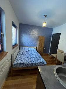 a bedroom with a bed in a room with a sink at Apartments Gaga in Jahorina +67 photos