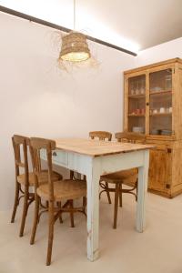 a dining room table with chairs and a chandelier at Maram Brava casa centro Begur Metge Pi in Begur +16 photos